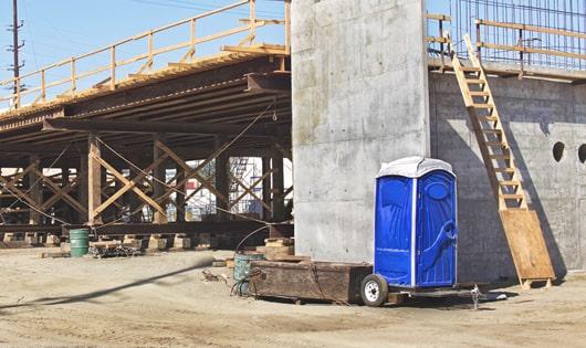 porta potties set up for workers’ use at a busy job site